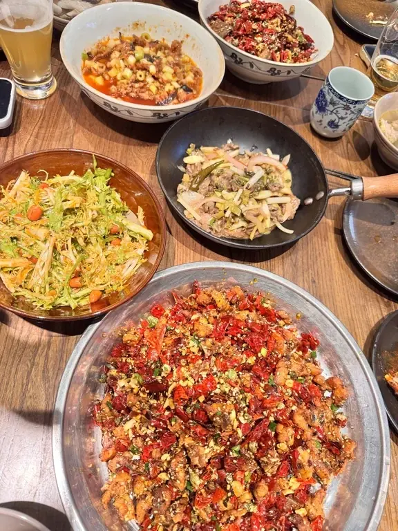 Several plates of stir-fried food on a table at Jia Wen Rou in Shanghai