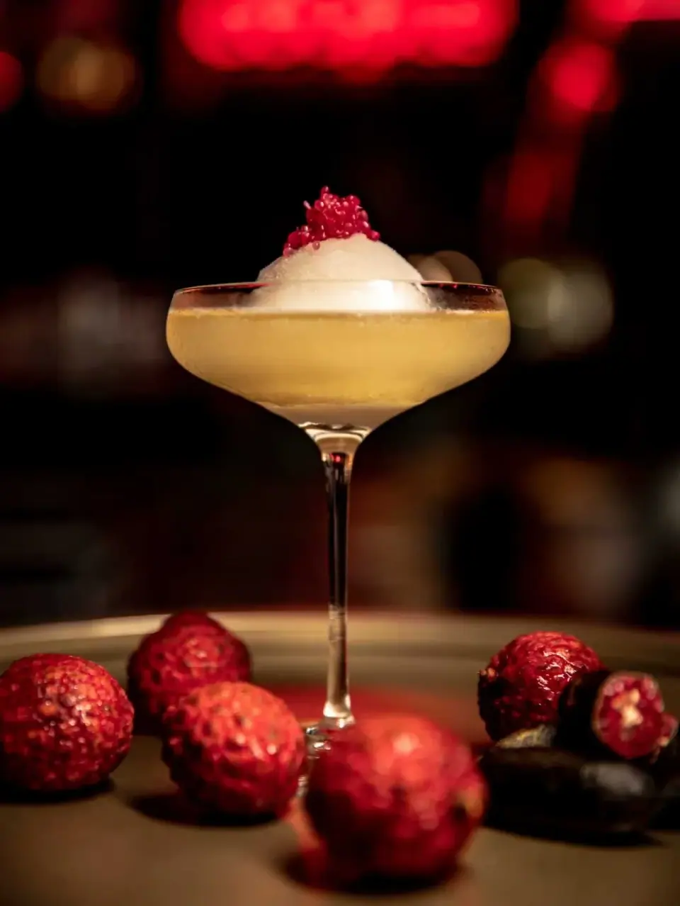 Strawberry-garnished cocktail in a stemmed glass at The Odd Couple Shanghai